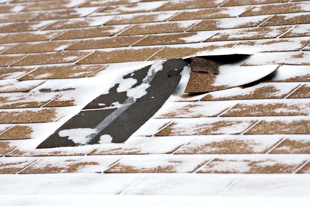 snowstorm damage to shingle roof